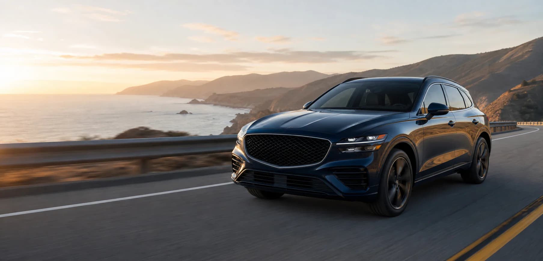 Midnight-blue crossover on a coastal road