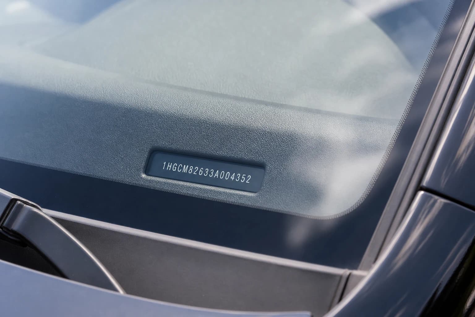 VIN plate visible through the lower driver-side windshield