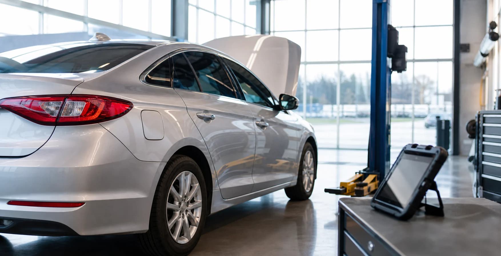 Vehicle being examined in a bright inspection bay